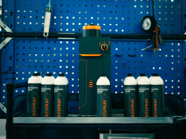 RSB refill machine with RESPRAY™ bottles installed in front of a workshop tool wall